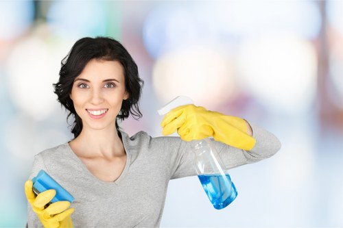 Professional domestic cleaner working in a Surrey kitchen and living area