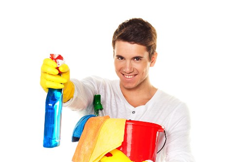 Staff member using protective equipment while handling cleaning products